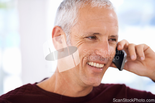 Image of Senior, man and happy with phone call in home for communication, discussion and mobile chat on weekend. Elderly, person and smile with smartphone for talking, retirement and networking in living room