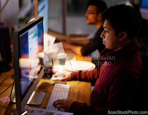 Image of Male employee, dark and coder on computer, night and late evening for project or deadline. Screen, technology and web online for software programmer, internet and cyber with colleague in office