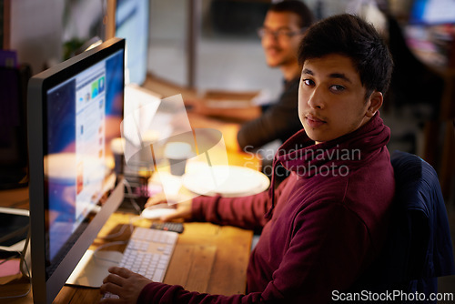 Image of Night, office and portrait of man with computer for online work as programmer or software developer for company. Male person, serious and technology for cloud engineer for websites and app designs.