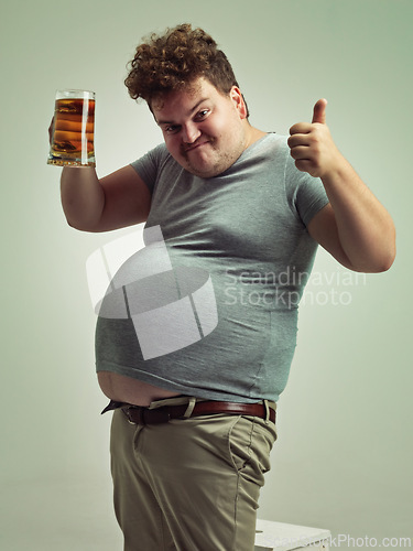 Image of Plus size, portrait and thumbs up from man with beer for unhealthy habit, stomach and weight gain in studio of white background. Emoji, hand and male person by alcohol, funny face and calories