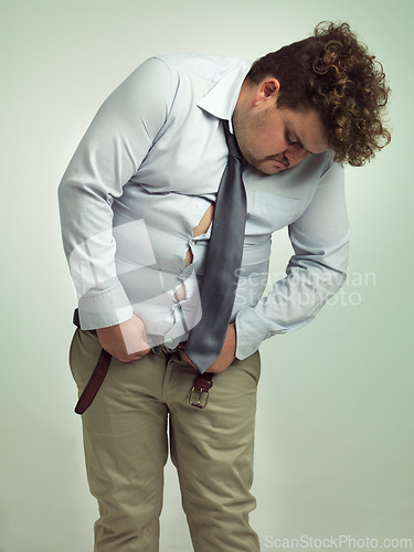 Image of Plus size, fitting and man unhappy with pants, shirt and professional clothes or suit for work. Adult, guy and male person with stomach or belly, upset and feeling frustrated with outfit for job