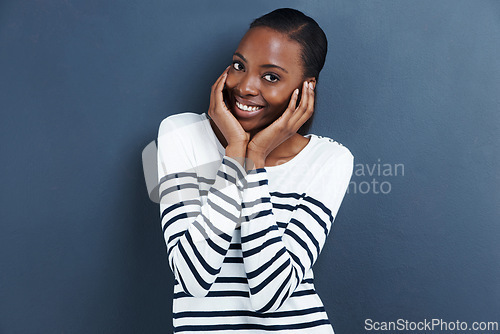 Image of Portrait, smile and black woman with reaction, shy and expression on a grey studio background. Face, person and model with social anxiety and embarrassed with mockup space and happy girl with emoji