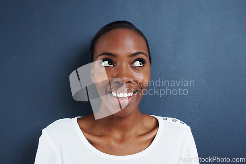 Image of Thinking, idea and happy black woman in studio with solution, insight or conclusion on blue background. Planning, problem solving and African female model with curious emoji for inspiration or memory