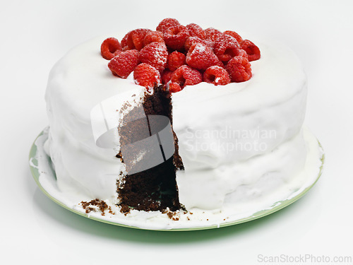 Image of Chocolate, dessert and blackforest cake for bakery, slice and raspberries for sweet snack. Fruit, icing and plate for display on table in pastry restaurant, creamy and baked confection with berries