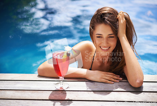 Image of Woman, smile and relax with cocktail in swimming pool with bikini for leisure, luxury and resort or villa. Girl, summer and tropical vacation or holiday in Maldives with beverage for sunbathing.