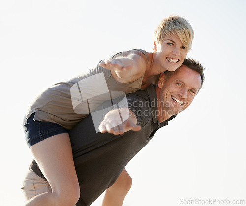 Image of Couple, portrait and happy outdoor with piggyback for bonding, honeymoon date and weekend holiday. Face, man and woman with embrace, smile and love in California for vacation, travel and adventure