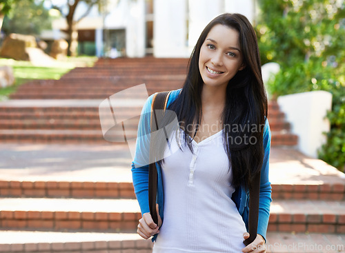 Image of Happy woman, portrait and student with backpack on campus for back to school, learning or education. Young female person or academic learner with smile and bag by staircase at college or university