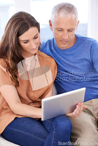 Image of Couple, tablet and relax on couch in home with reading, search and app to watch movie with bonding. People, woman and mature man on digital touchscreen for notification with web connection in house