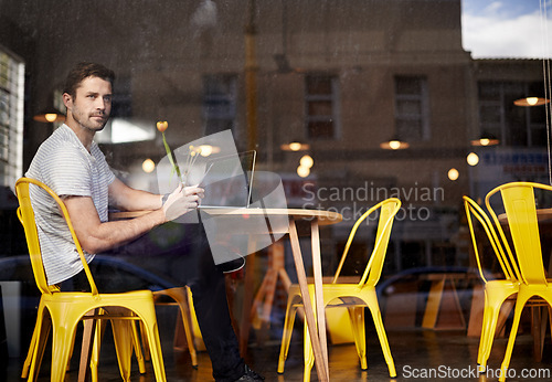 Image of Young man, thinking and vision with phone at cafe by window for social media or communication at indoor restaurant. Male person on mobile smartphone for online chatting, texting or app at coffee shop