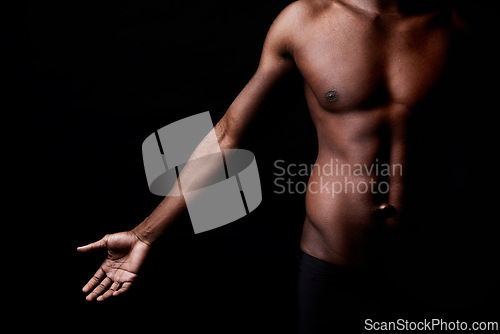 Image of Black man, body, and muscle with fitness in shadow for exercise or workout on a dark studio background. Closeup of young African male person or bodybuilder with masculine or muscular figure on mockup