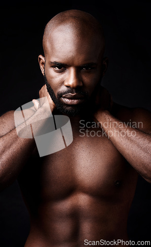 Image of Black man, portrait and model with muscle in fitness, fashion or masculine figure on a dark studio background. Face of attractive or serious African, male person or bodybuilder in health and wellness