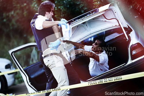 Image of Policeman, car and zombie at crime scene, horror and monster or scary infected person in trunk of vehicle. Authority, danger and supernatural beast or survivor, rescue and undead person for terror