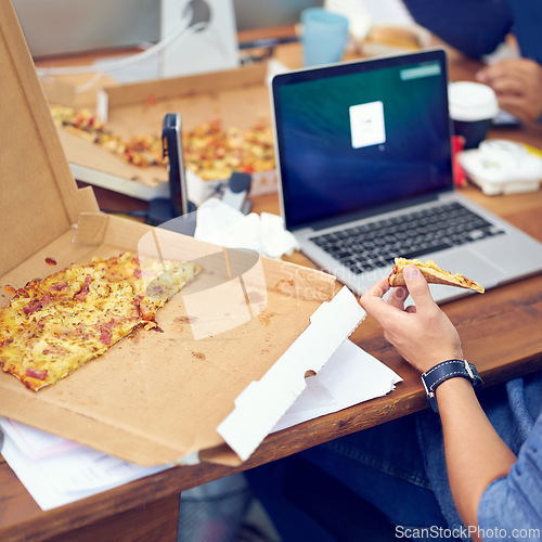 Image of Pizza, office and worker hands on laptop screen for programming, software and information technology. Person or programmer eating fast food at startup company or job with web development on computer