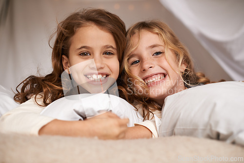 Image of Excited, sleepover and portrait of children in bedroom for playing, bonding and relax with toys in home. Happy, friends and young girls on bed in tent or blanket fort for childhood, fun and happiness