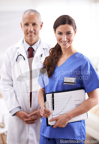 Image of Doctor, nurse and portrait with partner, smile or documents for chart to monitor wellness in hospital. Medic, man and woman in team with paperwork for healthcare services in clinic with pride for job