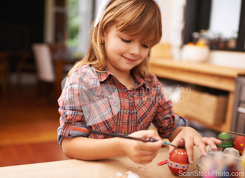 Image of Happy girl, paint and brushing egg with smile for colorful art, learning or education in creativity at home. Young child enjoying color, activity or artwork for early childhood development at house