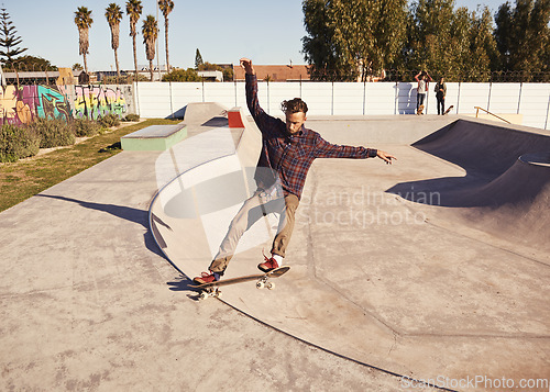 Image of Fitness, sports and man with skateboard, jump or ramp action at a skate park for stunt training. Freedom, adrenaline and gen z male skater with energy, air or skill practice, exercise or performance