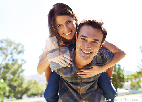 Image of Portrait, piggy back and couple with love, outdoor and bonding together with romance and sunshine. Face, man carrying woman and summer with weekend break and marriage with fun, play and relationship