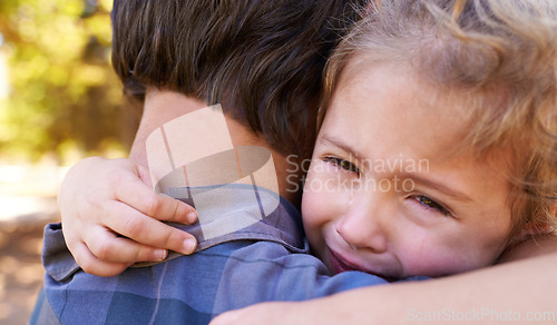 Image of Hug, sad girl and father in a park, emotions and expression with reaction and crying with single parent. Loss, family and outdoor with dad and daughter with embrace and grief with tears, adhd or pain