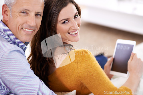 Image of Couple, portrait and smile with tablet in home with hug for bonding, screen and relax with social media or internet. Senior man, woman or face with digital display for subscription or embrace on sofa