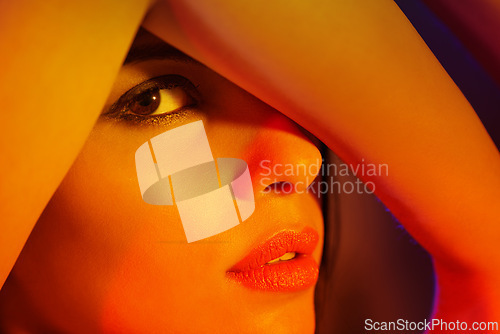 Image of Studio, woman or portrait in artistic lighting with eye peeping, creativity or cover with arm to hide. Model, cosmetic and creative face for art deco, aesthetic and skincare for dermatology or beauty