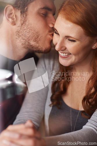 Image of Happy couple, kiss and love with embrace for support, intimacy or affection together at indoor cafe. Man and woman with affection on cheek for date, relationship or romantic bonding at coffee shop