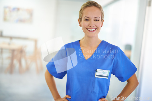 Image of Happy woman, portrait and nurse with confidence for healthcare, science or career ambition at hospital. Young female person, scrub or medical doctor with friendly smile or PHD of expert at the clinic