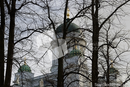 Image of domes of Helsinki Cathedral behind silhouettes of trees