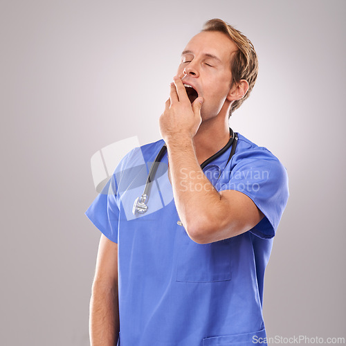 Image of Doctor, studio and yawn for overworked, tired and burnout with stethoscope for job. Man, specialist and stress for professional, medic and health care or medical pressure isolated on white background