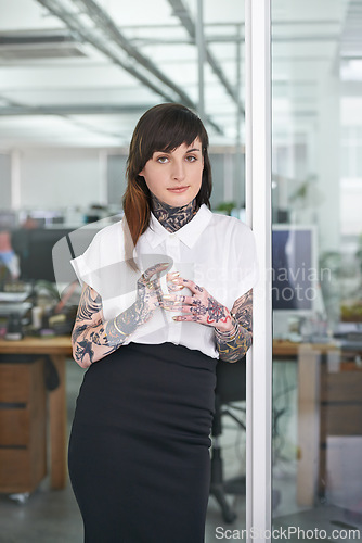 Image of Happy, tattoos and business woman with coffee in office with positive, good and confident. Grunge, cappuccino and portrait of professional edgy creative designer with ink skin standing in workplace.