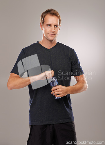 Image of Thinking, studio or man drinking water for fitness, hydration or workout break isolated on grey background. Healthy person, training or thirsty athlete with h2o liquid drink for exercise or detox