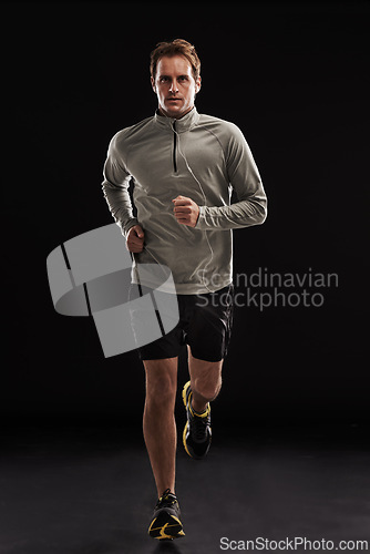 Image of Man, portrait and cardio running in studio for athlete performance or marathon, training or black background. Male person, face and fitness sports with mockup space for health, workout or exercising