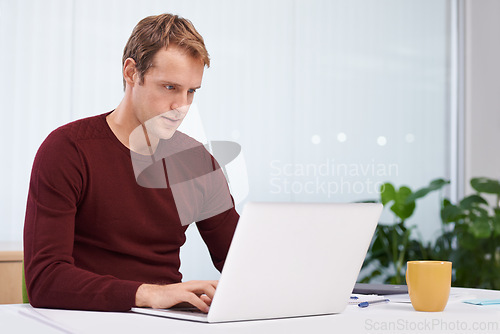 Image of Businessman, laptop and online research in office with paperwork as graphic designer. entrepreneur or project planing. Male person, typing and desk for creative agency or career, email or internet