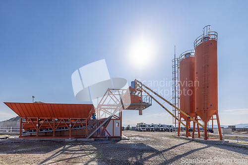 Image of Cement plant with silos and machinery