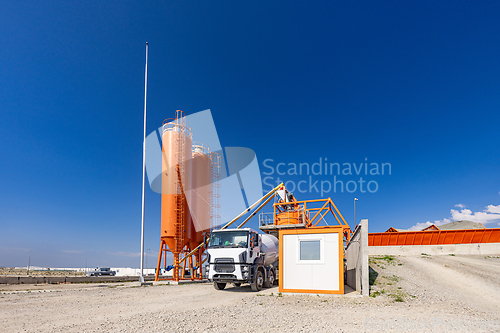 Image of Concrete batching plant with a mixing tower and cement truck