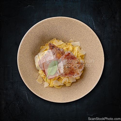 Image of Juicy pork chops on a bed of pasta