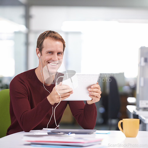 Image of Tablet, portrait and businessman with earphones, desk and working in office workplace. Smile, technology and watching business videos or streaming, elearning and internet research for online project