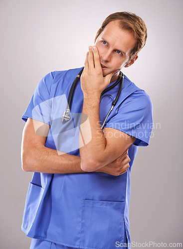 Image of Doctor, studio and thinking for planning, vision and working with stethoscope for job. Man, specialist and expert for professional, medic and health care or medicine isolated on white background