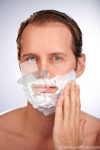 Image of Man, portrait and shaving cream for beard in studio or hair removal maintenance, grooming or white background. Male person, face and product for healthy hygiene with skincare, dermatology or mockup