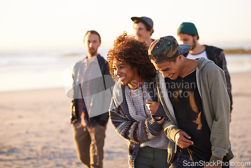 Image of Travel, beach and laughing friends walking in nature for vacation, bonding or holiday together at sunset. Happy, journey or gen z group of people at sea for fresh air, conversation or ocean adventure