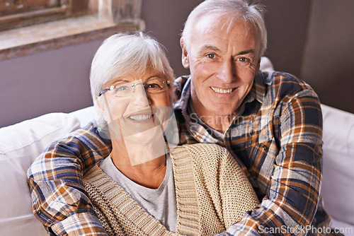 Image of Senior couple, hug and portrait on sofa with smile, love and connection in living room for retirement. Elderly woman, old man and embrace on couch in lounge with pride, care and happy in apartment