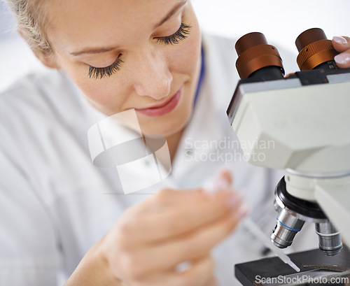 Image of Woman, microscope and drop with test for laboratory research, scientific exam or discovery at clinic. Face of female person or medical expert with smile and scope for science breakthrough or biology