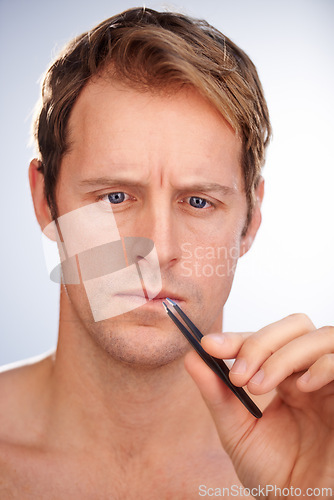 Image of Man, tweezers and eyebrow hair removal in studio for grooming, skincare or mockup space. Male person, tool and plucking for dermatology microblading for transformation, cosmetic or white background