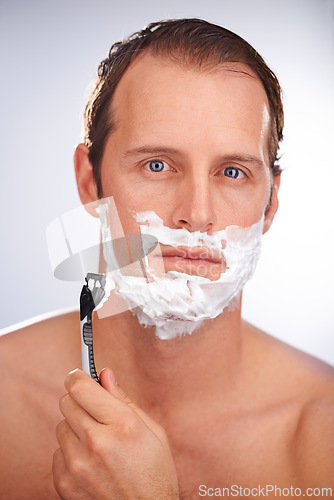 Image of Man, portrait and shaving cream with razor for beard hair removal or grooming, maintenance or white background. Male person, face and smile with tool for dermatology hygiene, studio or mockup space