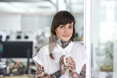 Image of Smile, tattoos and business woman with coffee in office with positive, good and confident. Grunge, cappuccino and portrait of professional edgy creative designer with ink skin standing in workplace.