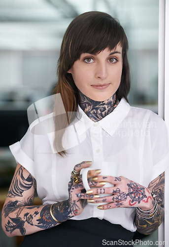 Image of Tattoos, coffee and portrait of business woman in office with positive, pride and confident attitude. Grunge, smile and edgy female creative designer with ink skin standing in modern workplace.