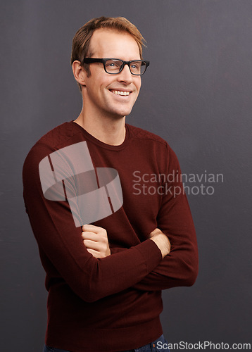 Image of Man, thinking and happy nerd in studio with arms crossed and inspiration on dark background. Planning, ideas and programmer brainstorming a development of solution for IT project update in mockup