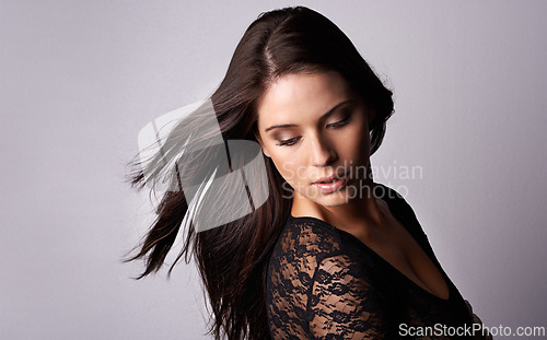Image of Makeup, beauty and woman in studio for hair, cosmetics or wellness treatment on grey background. Glamour, makeover and female model with haircare results, shampoo or growth, texture or satisfaction
