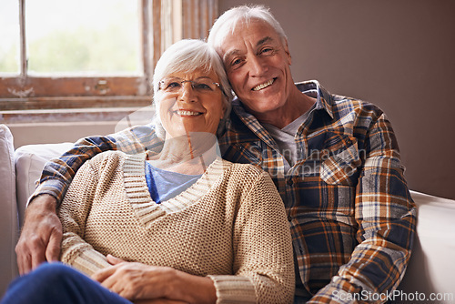 Image of Senior couple, happy and portrait in sofa with hug, love and connection in living room for retirement. Elderly woman, old man and embrace on lounge couch with pride, care and smile in apartment