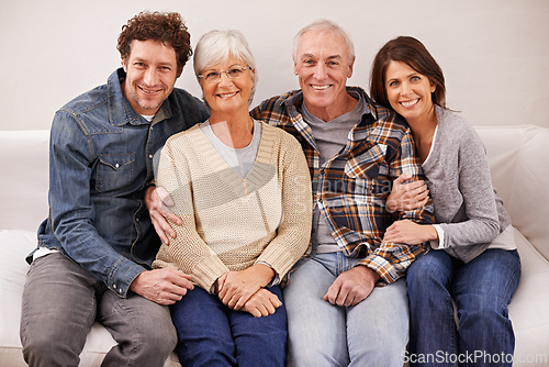 Image of Couple, elderly parents and portrait on sofa with smile, hug and care with bonding, relax and pride in home. Father, mother and happy with women, men and embrace with love on couch in family house